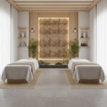 Calming massage room featuring beige and brown wooden tiles, soft lighting, and minimalist decor for a tranquil spa experienc.