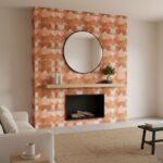 Terracotta-colored textured tile with geometric pattern, round mirror, and minimalist decor in a cozy living room.