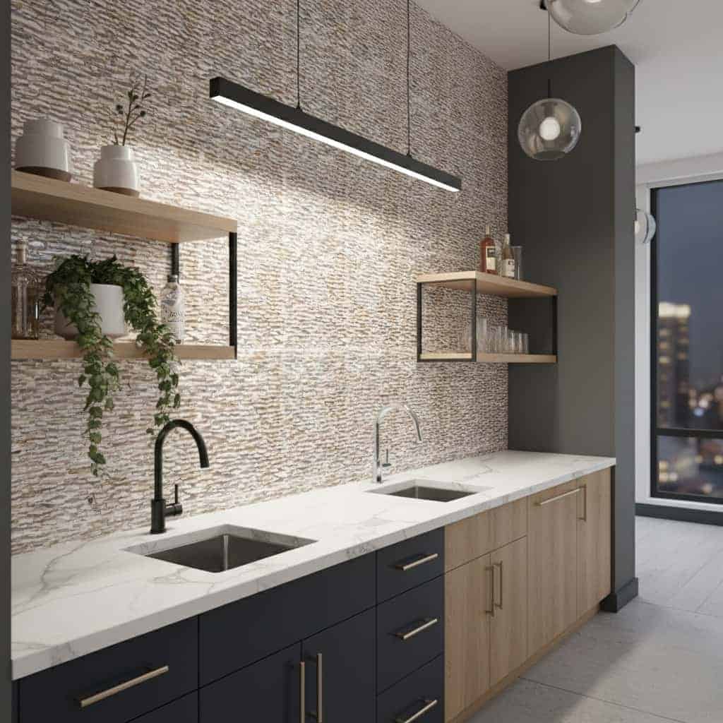 Textured beige and gray wall tiles with a natural stone appearance, complementing the sleek black and wood cabinetry.