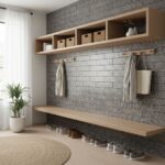 A modern entryway with a textured gray tile wall, wooden shelves, and hooks for hanging coats and bags, complemented by a pot.