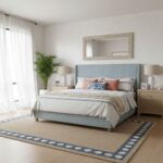 Cozy bedroom with light blue upholstered bed, neutral decor, and natural light.