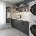 Bright laundry room with dark gray cabinets and white marble countertop. Features textured tile backsplash and open wooden sh.
