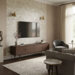 Beige textured wall with gold wall sconces and a mounted flat-screen TV.