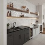 Black and white textured tile backsplash with wooden shelves and gold faucet in a contemporary kitchen setting.