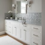 White mosaic tile backsplash with gray accents, smooth texture, and glossy finish.