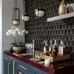 Dark blue and gold geometric patterned tile with a glossy finish.