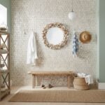 Decorative shell-patterned wall tile in neutral tones.