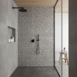 Black and white mosaic tiles with a matte finish in the shower wall area.
