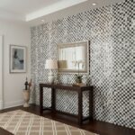 A black and white checkered ceramic tile wall with a textured surface, creating a bold, modern look in the interior space.