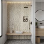 Bright beige and white geometric patterned tile in shower area.