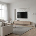 Modern living room with textured white tile wall behind a flat-screen TV, light wood floating console, and minimalist decor.