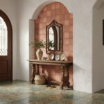 Terracotta-colored ceramic tiles with textured surface and matte finish in entryway.