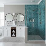 Blue glass mosaic tiles with a textured surface, used on the shower wall for a vibrant, modern look.