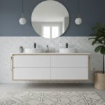 Modern bathroom vanity with white ceramic sinks, black faucets, and a large round mirror.