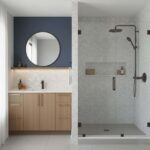 Bright white marble shower and vanity tiles with a smooth, polished texture and subtle gray veining.