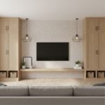 Contemporary living room wall featuring light wood cabinets, a flat-screen TV, and decorative plants, creating a cozy and sty.