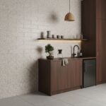 Beige textured tile wall with dark wood kitchen cabinetry and black fixtures.