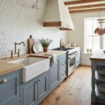 Bright kitchen with blue cabinetry, white farmhouse sink, and natural wood accents. Features a textured wall, wooden countert.